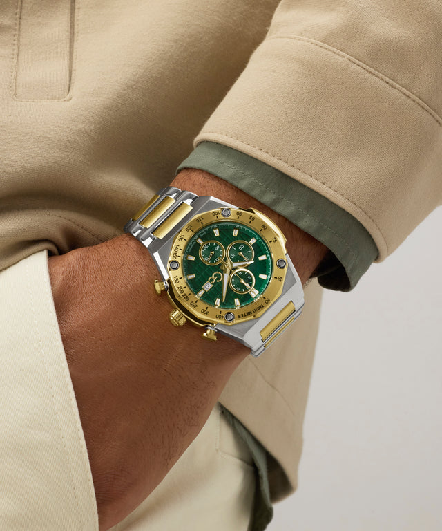 Close-up of a wrist wearing a gold and green Gc IdolSport Chrono Metal with a beige coat.