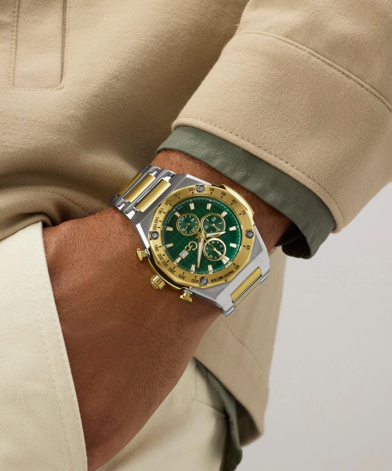 Close-up of a wrist wearing a gold and green Gc IdolSport Chrono Metal with a beige coat.