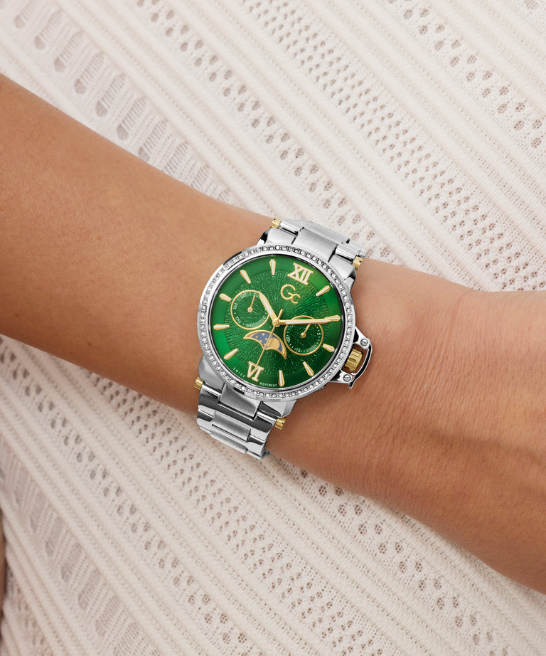 Green Gc MoonChic Large Size Metal with silver case on a wrist against a white lace background