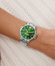 Green Gc MoonChic Large Size Metal with silver case on a wrist against a white lace background