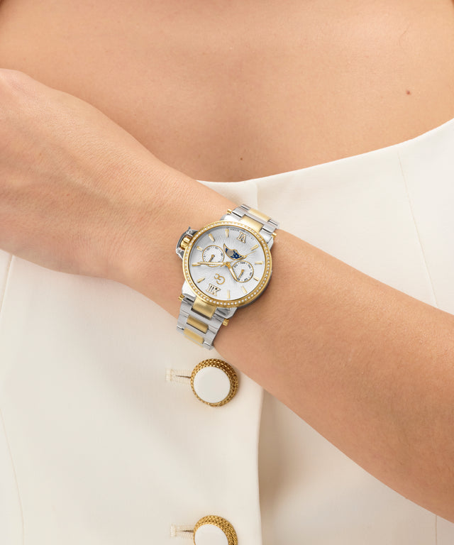 Gold and silver Gc MoonChic Large Size Metal on a wrist with a plain background
