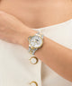 Gold and silver Gc MoonChic Large Size Metal on a wrist with a plain background