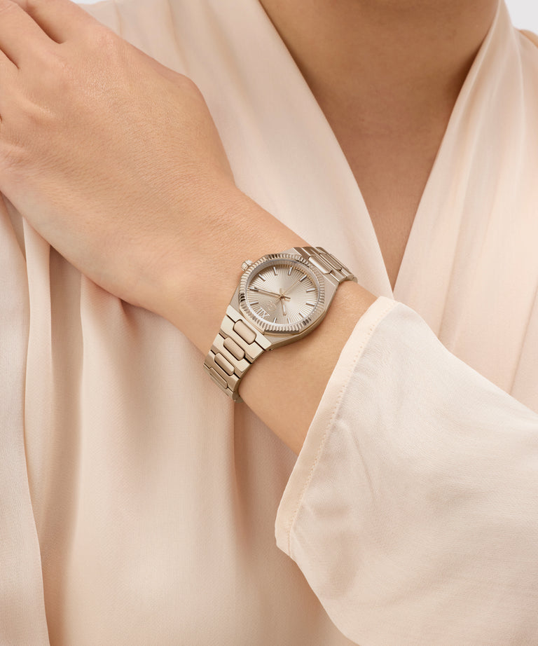 Silver Gc Prodigy Lady Mini Small Size Metal watch on a wrist with a light beige background