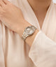 Silver Gc Prodigy Lady Mini Small Size Metal watch on a wrist with a light beige background