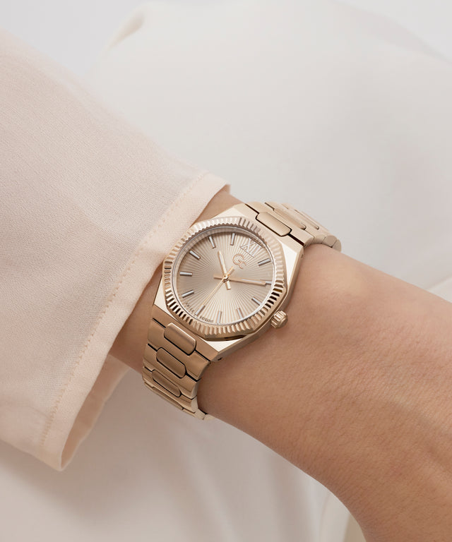 Gold Gc Prodigy Lady Mini Small Size Metal wristwatch on a person's wrist with a neutral background