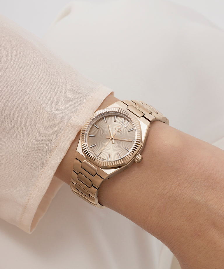 Gold Gc Prodigy Lady Mini Small Size Metal wristwatch on a person's wrist with a neutral background