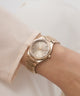 Gold Gc Prodigy Lady Mini Small Size Metal wristwatch on a person's wrist with a neutral background