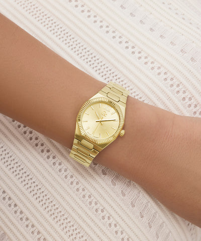 Gold Gc Prodigy Lady Mini Small Size Metal watch on a wrist with a textured white background