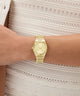 Gold Gc Prodigy Lady Mini Small Size Metal watch on a person's wrist with a light background