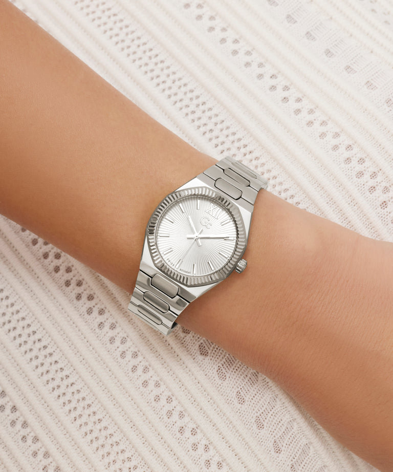 Silver Gc Prodigy Lady Mini Small Size Metal watch on a wrist with a white lace background