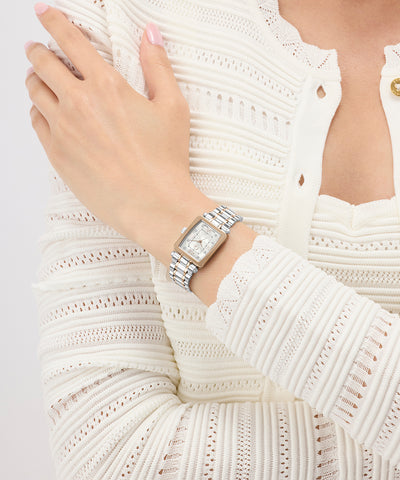 Silver Gc Plaza Mini Small Size Metal watch on a person's wrist with a white textured sweater