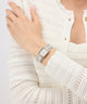 Silver Gc Plaza Mini Small Size Metal watch on a person's wrist with a white textured sweater