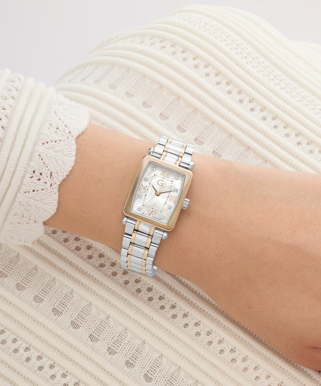 Silver Gc Plaza Mini Small Size Metal watch on a wrist with a white lace background