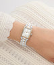 Silver Gc Plaza Mini Small Size Metal watch on a wrist with a white lace background