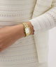 Gold Gc Plaza Mini Small Size Metal watch on a wrist with a white textured sweater