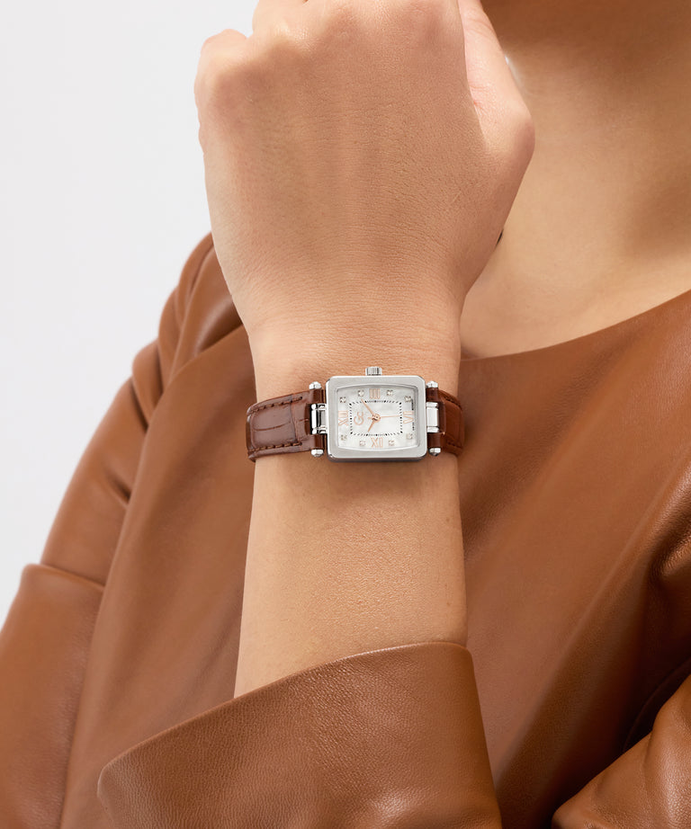 Gc Plaza Mini Small Size Leather Watch with a brown leather strap on a wrist, against a neutral background