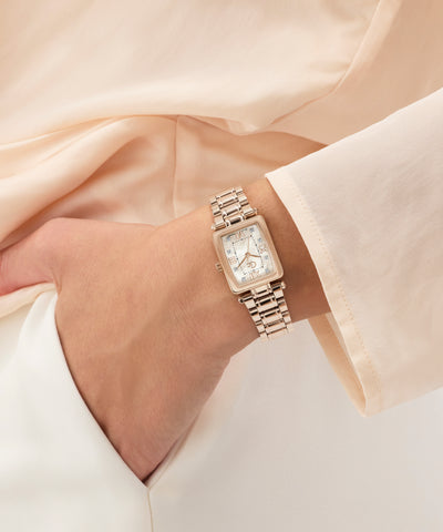 Gold Gc Plaza Mini Small Size Metal watch on a wrist with a soft beige background