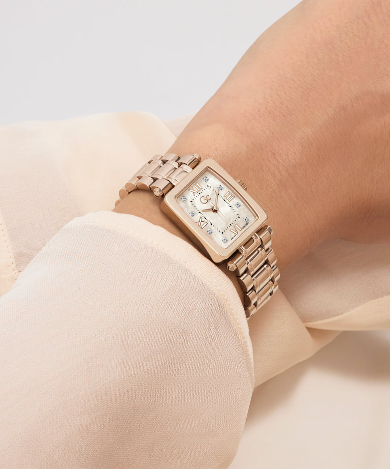 Rose gold Gc Plaza Mini Small Size Metal watch on a wrist with a neutral background