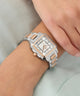 Silver and rose gold Gc SquareCut Lady Mid Size Metal watch on a wrist with a light background