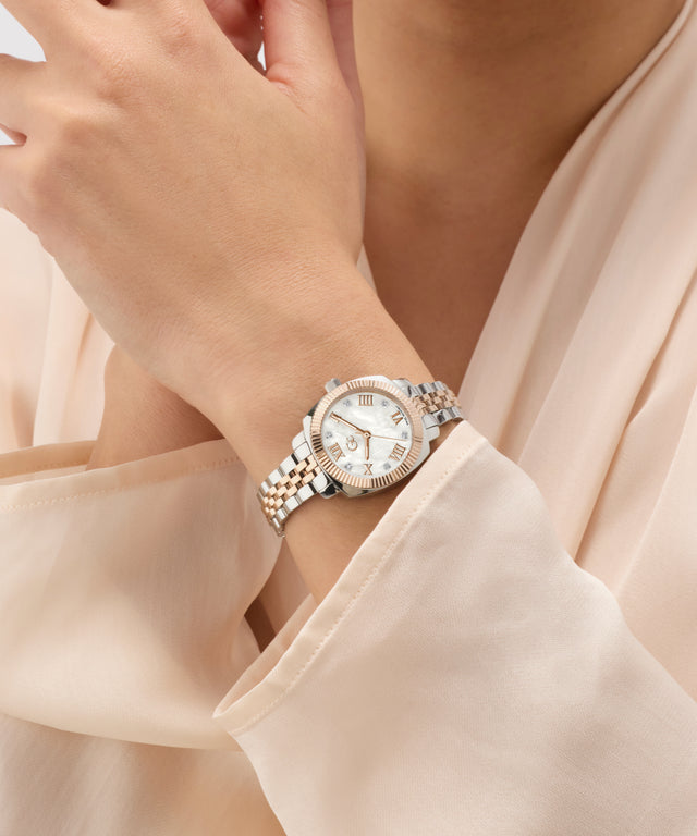 Gc Flair Coussin Mini Small Size Metal on a wrist with a beige blouse