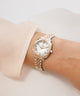 Gold Gc Flair Coussin Mini Small Size Metal on a wrist with a plain background