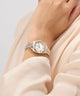Close-up of a wrist wearing a rose gold Gc Flair Coussin Mini Small Size Metal with a light background