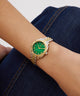 Gold and green Gc Flair Coussin Mini Small Size Metal on a wrist with a denim background