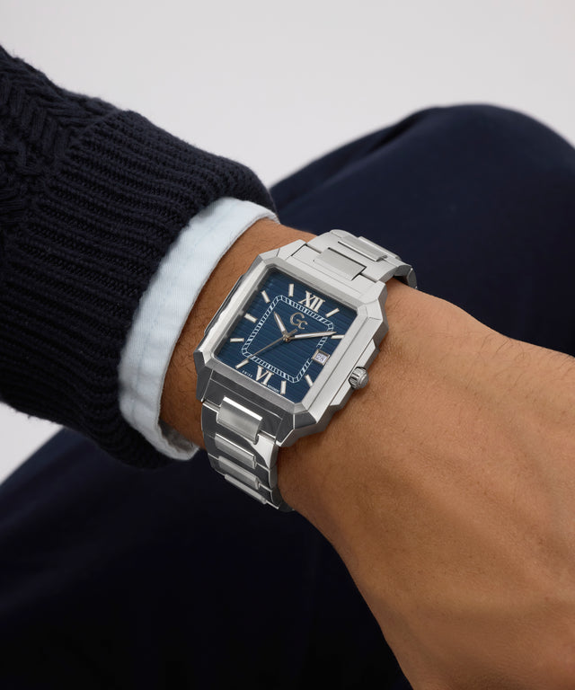 Silver Gc SquareCut Metal watch on a wrist with a white shirt cuff against a neutral background