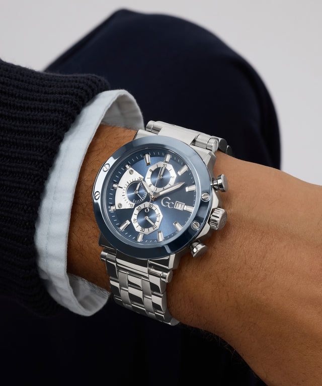 Silver Gc TechnoForce Chrono Metal watch with a black face on a wrist against a neutral background