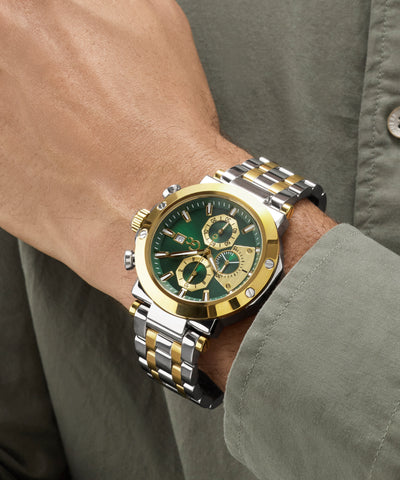 Gold and silver Gc TechnoForce Chrono Metal watch with green face on a wrist, wearing a green shirt.