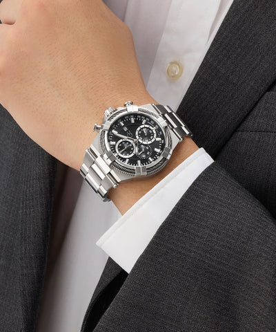 Silver Gc IronForce Chrono Metal on a person's wrist with a suit and white shirt background