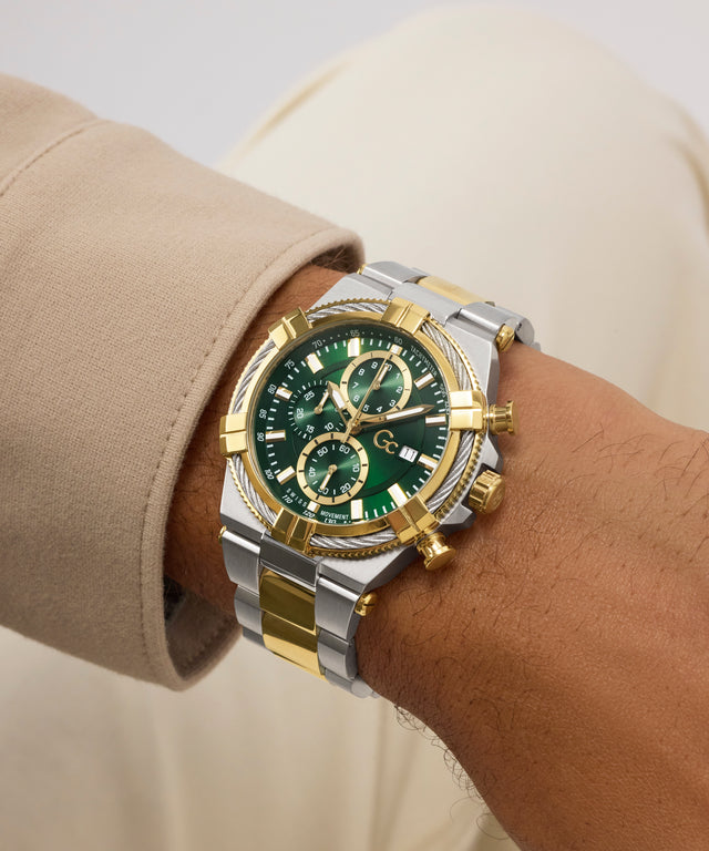 Luxury Gc IronForce Chrono Metal with green face and gold accents on a wrist against a neutral background