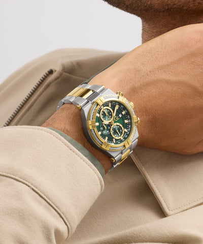 Close-up of a person wearing a silver and gold Gc IronForce Chrono Metal with a green face.