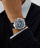Close-up of a person wearing a silver Gc IronForce Chrono Silicone with a black strap.