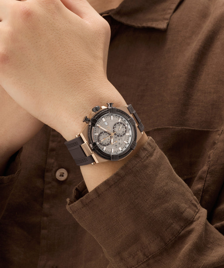 Close-up of a wrist wearing a stylish Gc IronForce Chrono Silicone with a brown shirt.