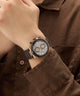 Close-up of a wrist wearing a stylish Gc IronForce Chrono Silicone with a brown shirt.