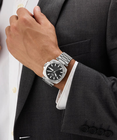 Silver Gc Nobilis Metal on a person wearing a dark suit and white shirt