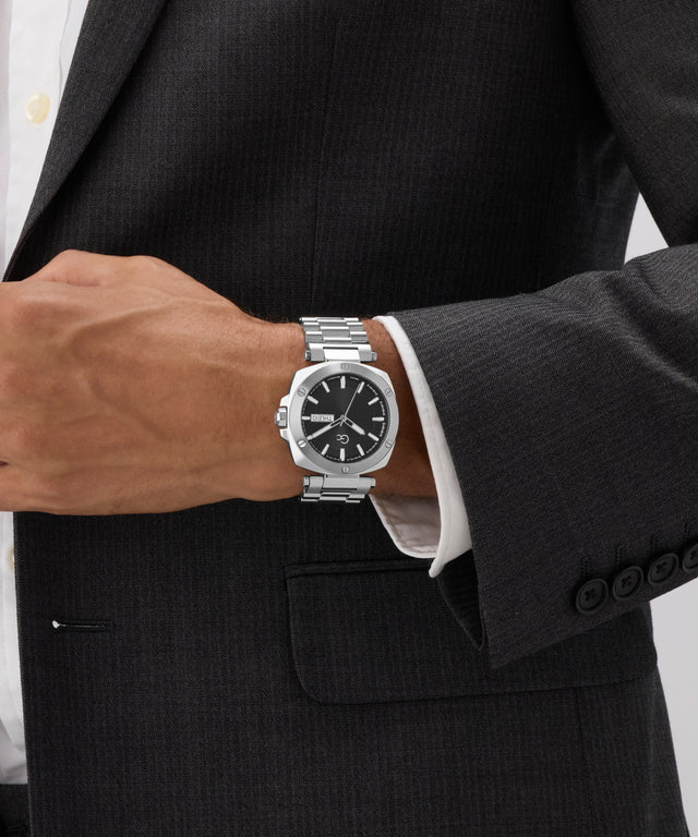 Silver Gc Nobilis Metal on a person wearing a black suit with a white shirt.