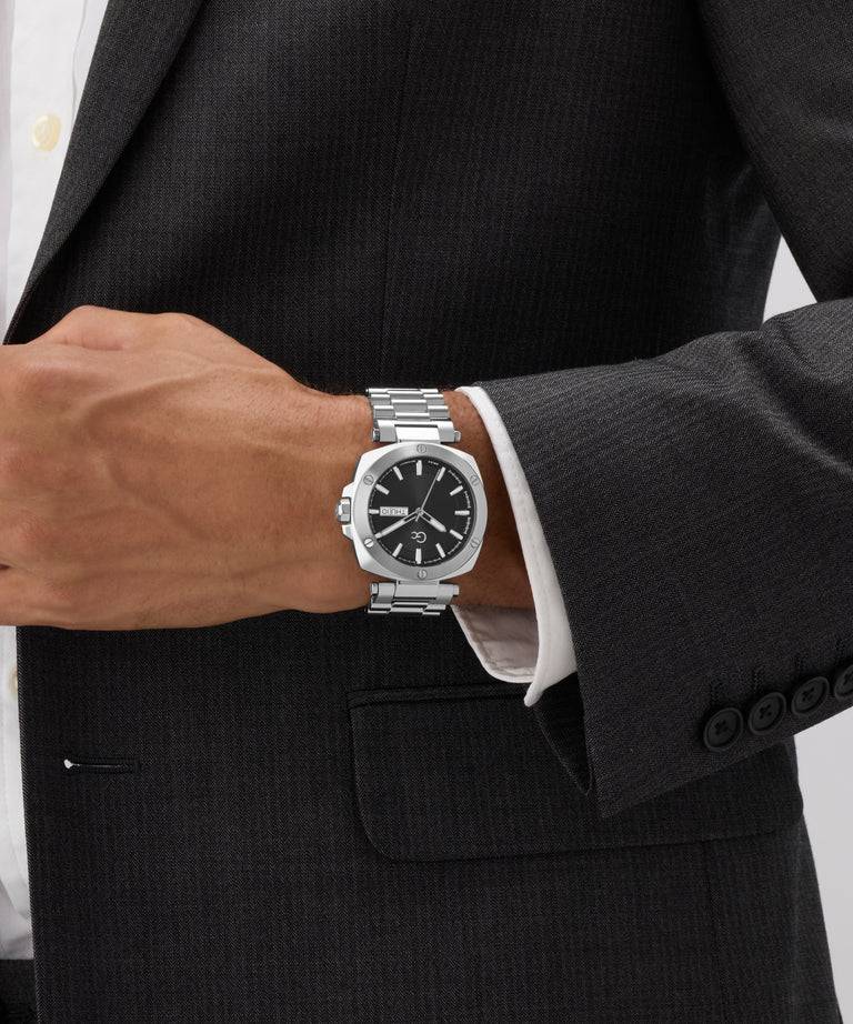 Silver Gc Nobilis Metal on a person wearing a black suit with a white shirt.