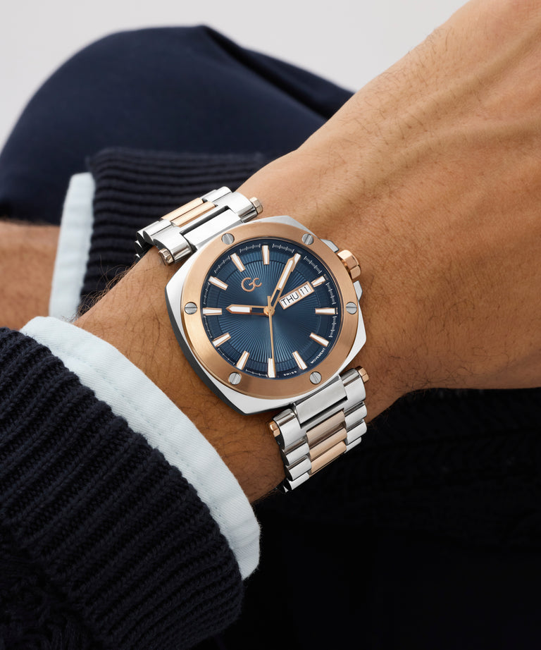 Close-up of a wrist wearing a silver and blue Gc Nobilis Metal with a blurred background
