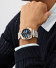 Person wearing a silver and rose gold Gc Nobilis Metal with a dark face.