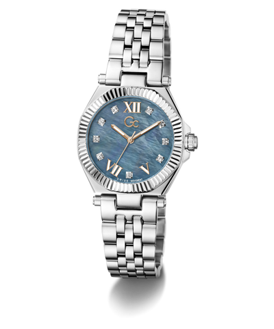 A women's stainless steel wristwatch with a fluted bezel, a blue mother-of-pearl dial with Roman numerals, and a matching steel link bracelet, shown on a white background.