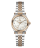 A two-tone stainless steel and rose gold watch with a white mother-of-pearl dial, crystal rhinestone hour markers, and a fluted bezel, shown on a plain white background.
