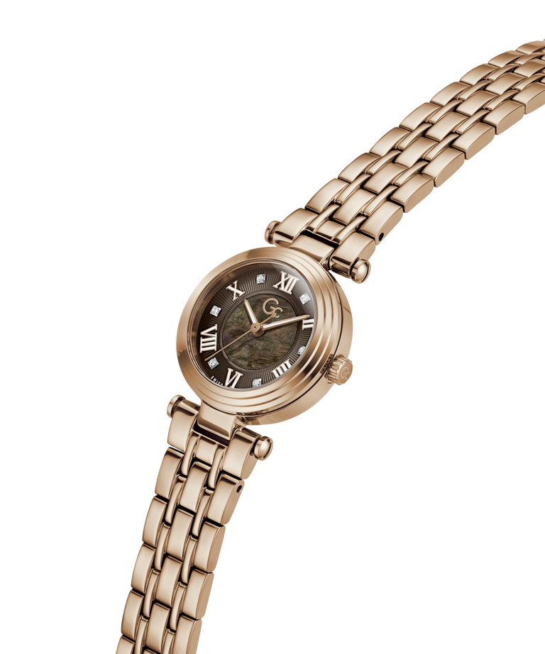 A rose gold women's watch with a multi-link bracelet, featuring a dark dial with Roman numerals and a central landscape image. lifestyle