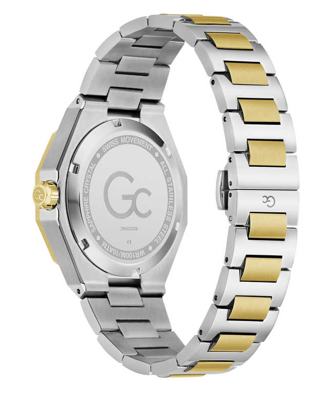 Rear view of a stainless steel and gold-tone watch with a two-tone metal link bracelet, showing the engraved case back and clasp on a white background.