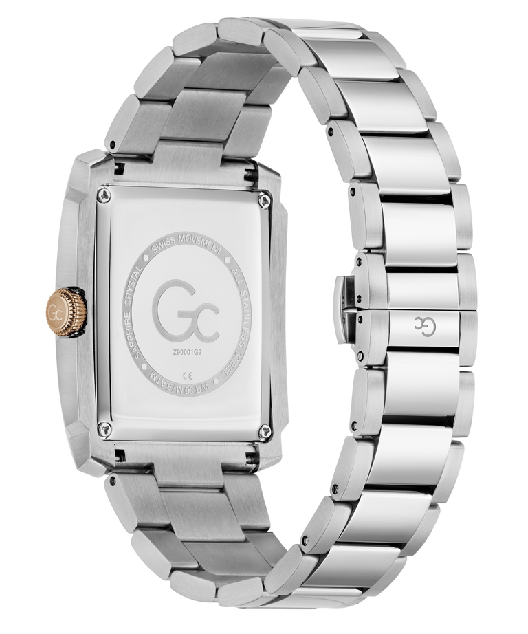 The back view of a stainless steel watch with a rectangular case and a matching metal link bracelet, featuring a brushed and polished finish. The dial is blanked out with a circular logo containing 'Gc' and 'TWENTYTHREE'.