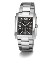 A stainless steel men's watch with a rectangular case, black dial, gold-tone hands and markers, and a matching steel link bracelet, shown on a clean white background.