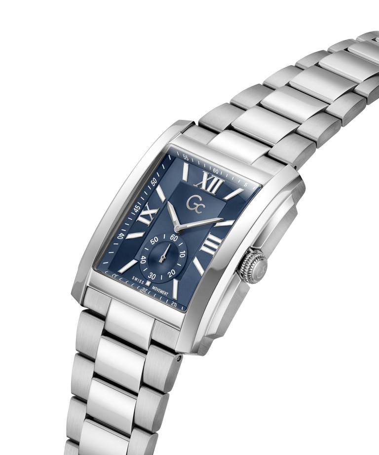 A silver stainless steel wristwatch with a rectangular blue dial, Roman numeral hour markers, and a matching silver metal link bracelet, shown on a plain white background. lifestyle