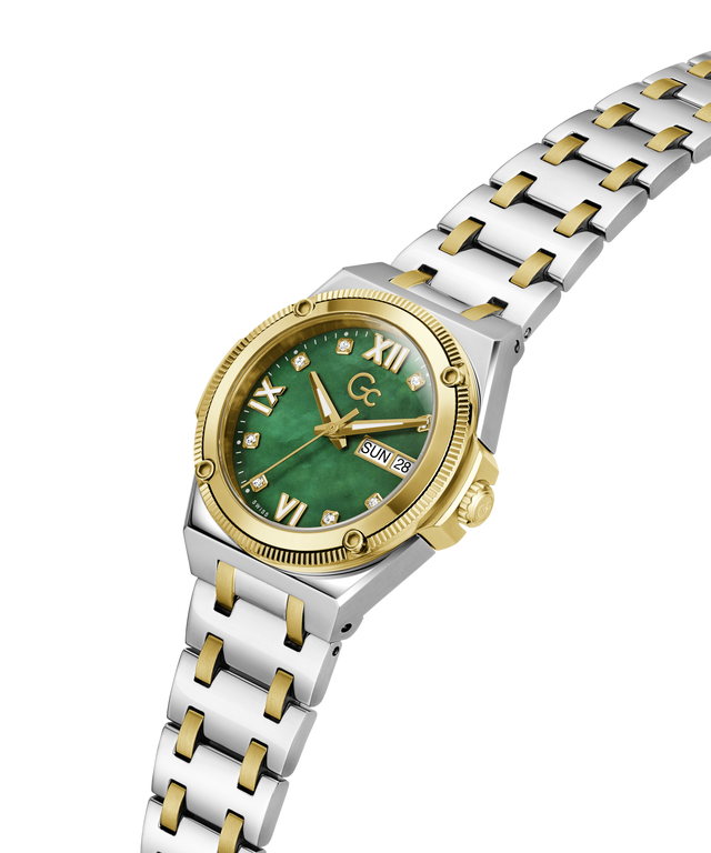 A two-tone stainless steel and gold wristwatch with a green dial, Roman numeral hour markers, a date window, and a matching two-tone link bracelet, shown on a plain white background. lifestyle