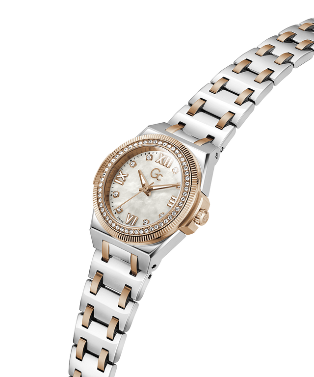 A two-tone stainless steel and rose gold watch with a mother-of-pearl dial, crystal-encrusted bezel, and matching link bracelet, shown on a plain white background. lifestyle